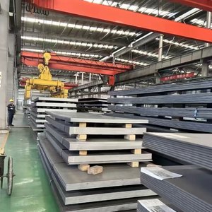 Heavy steel plate stock stacked in a workshop warehouse