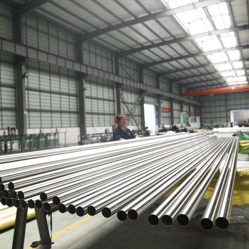 Long stainless steel pipe lengths in workshop
